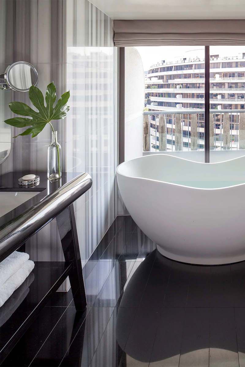 Free standing tub in modern style bathroom with outdoor view