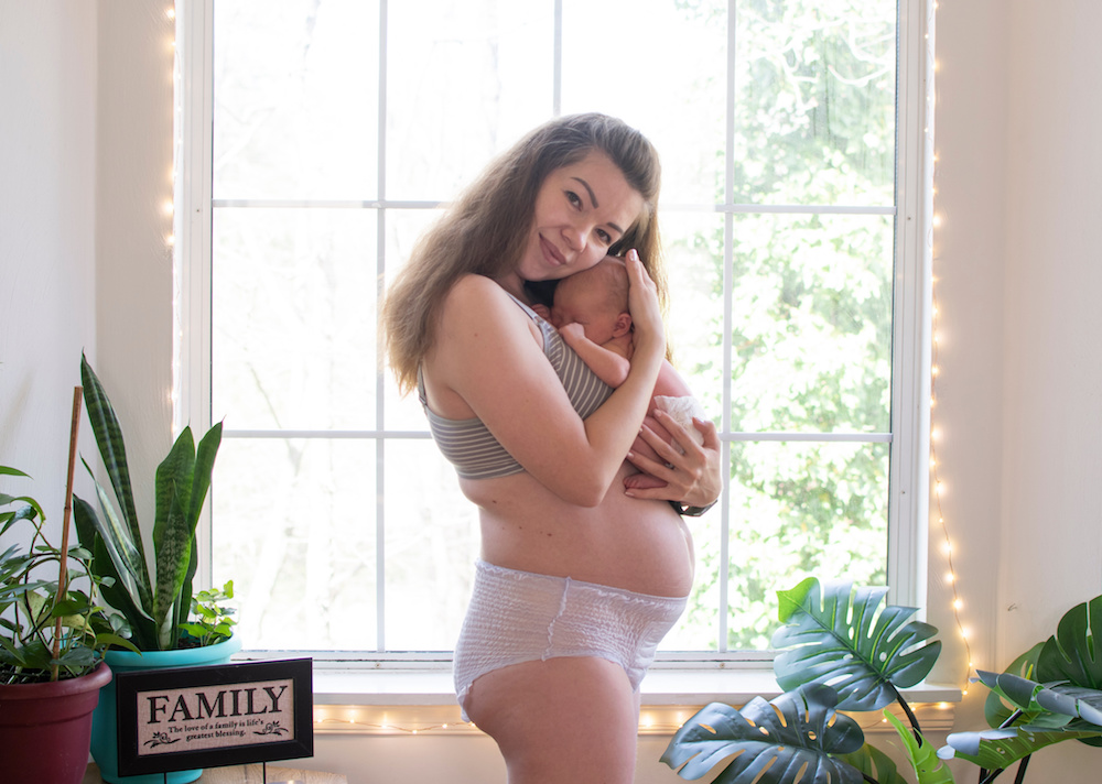 postpartum fourth trimester mom holding baby