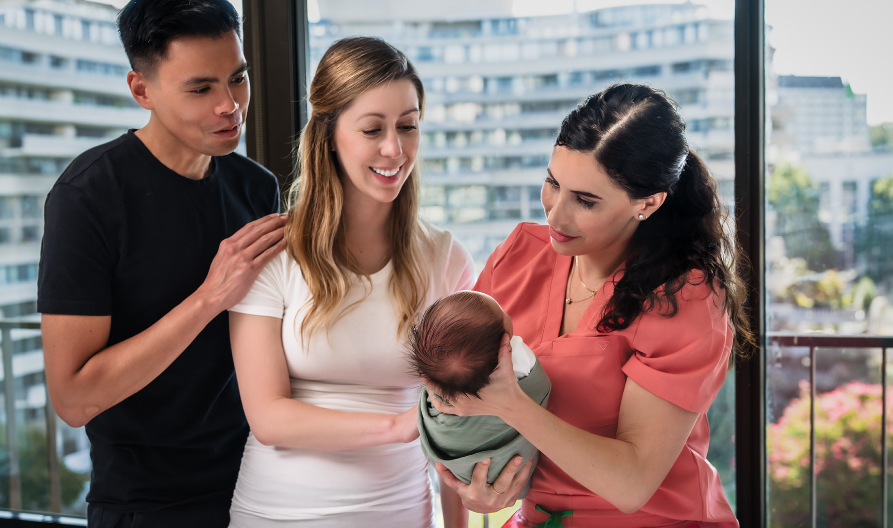 consultant showing couple how to hold a baby
