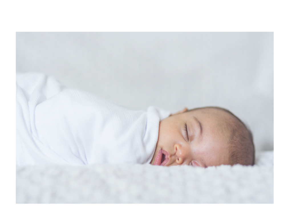 cold and flu season tips for baby sleeping in white swaddle 